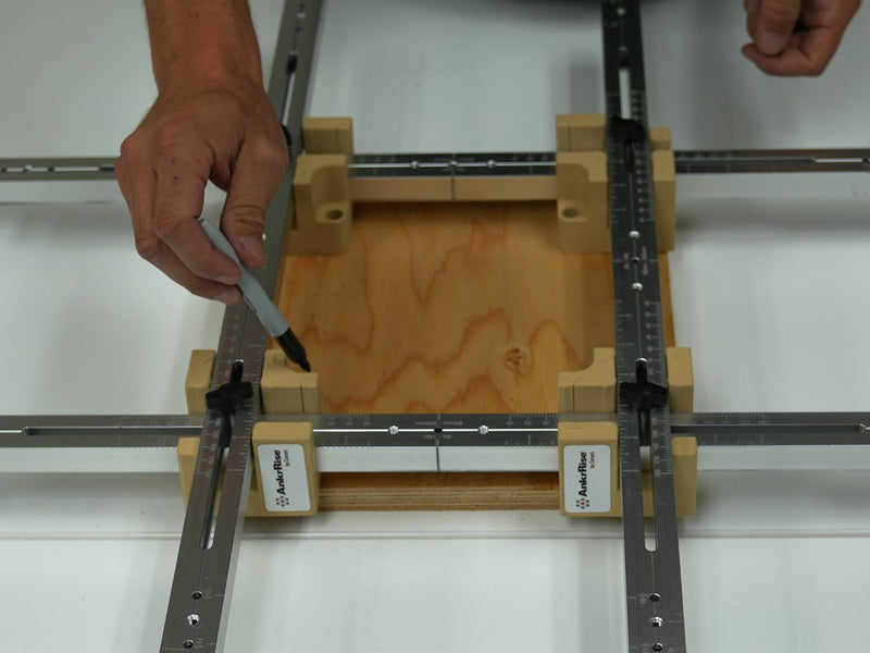 Marking drilling spots on a plywood template with a Sharpie through the AnkrRise