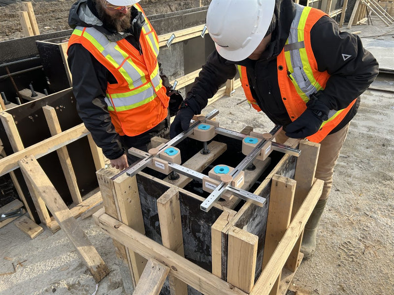 Crew checking an anchor template in the formwork on a job site with the AnkrRise